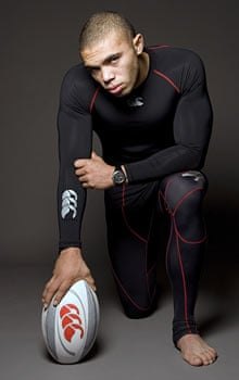 Bryan Habana kneeling with a rugby ball in a Canterbury shoot